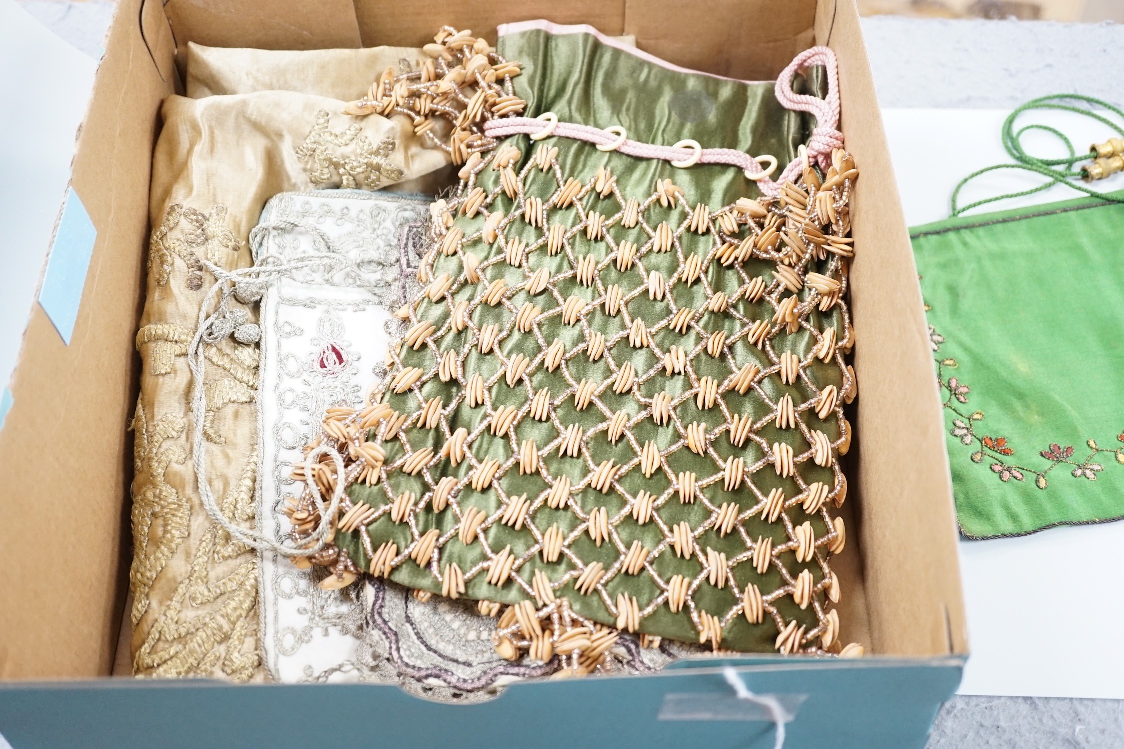 An Indian metal thread embroidered table cover and a collection of crochet, woven and embroidered bags, some with ribbon-work and cut steel and seed decoration